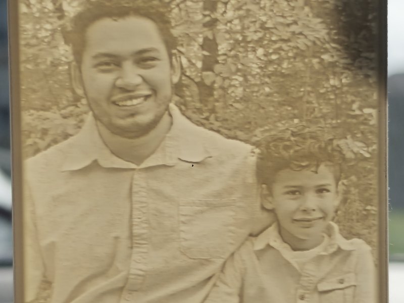 Close-up of a car lithophane of a dad and son, the whole photo glowing with detail in daylight