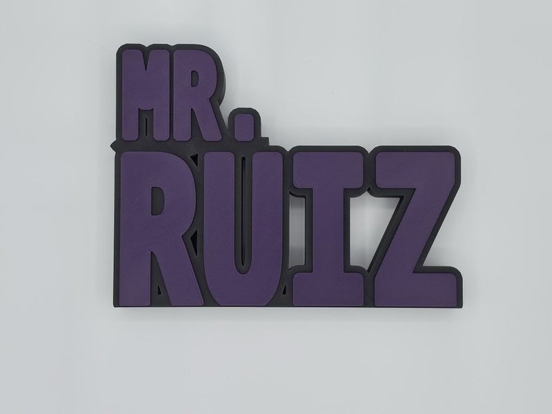 3D-printed freestanding purple and black nameplate reading MR. RUITZ